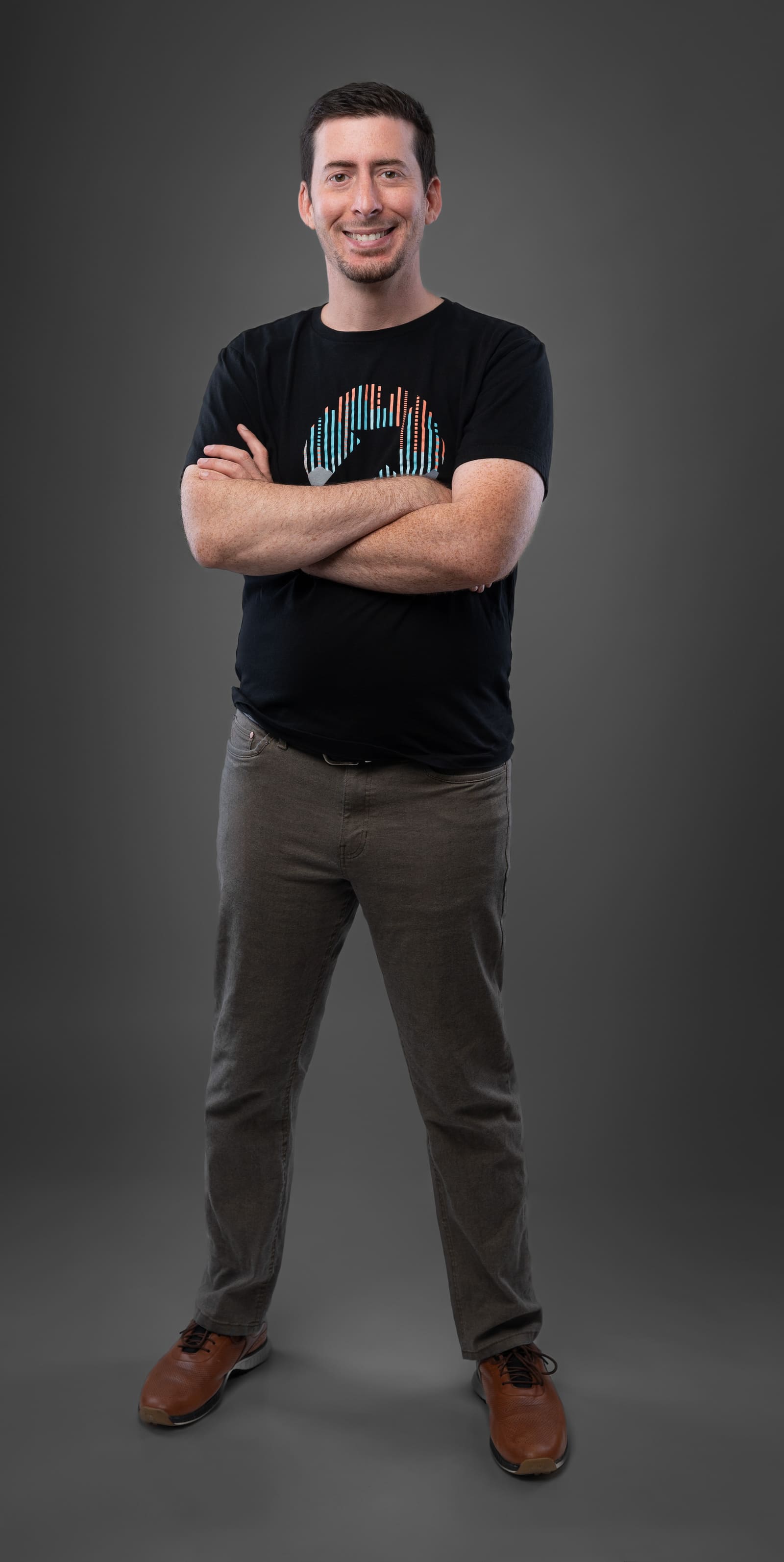 Jake Goldman, jacket off, arms crossed